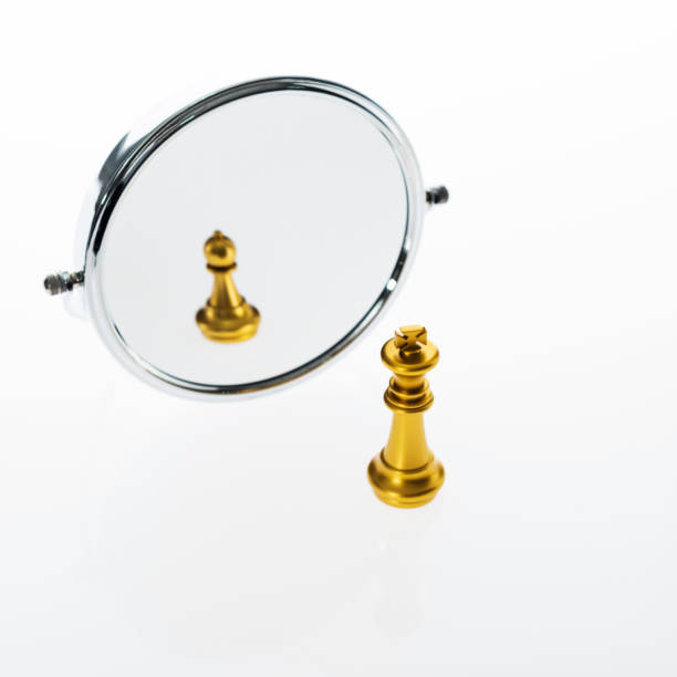 istock Golden chess king imagining itself as a pawn 1182775153