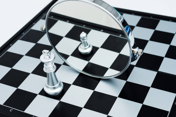 istock Silver chess king imagining itself as a pawn 1182775201