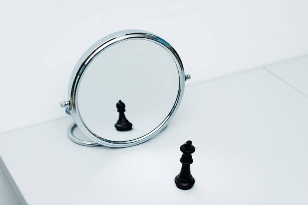 istock Black chess king imagining itself as a pawn 1182775275