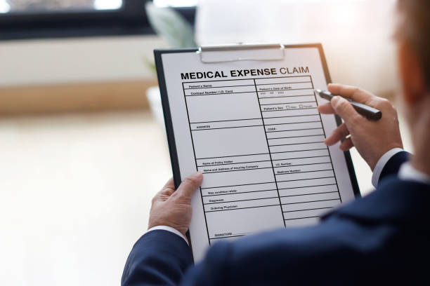 istock Businessman checking document and completing a insurance claim form at office work, insurance protection concept 1182775791