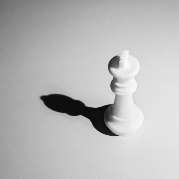 istock White chess king with the shadow of a pawn 1182775996