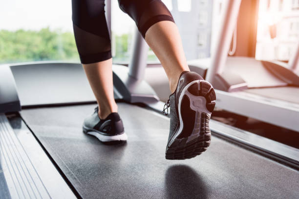 Woman running exercise on track treadmill stock photo