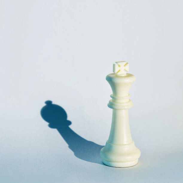 istock White chess king with the shadow of a pawn 1182776105
