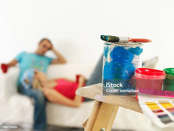 Young Couple With Wall Paints On Focus Stock Photo - Download Image Now - House Painter, Paint Can, 30-39 Years