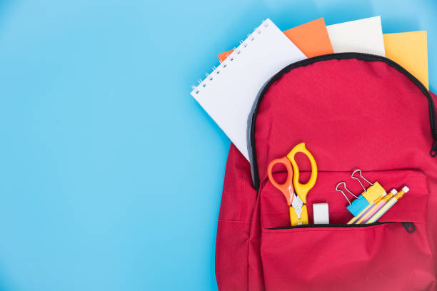 istock Top view Red bag backpack for education children on blue background 1182778455