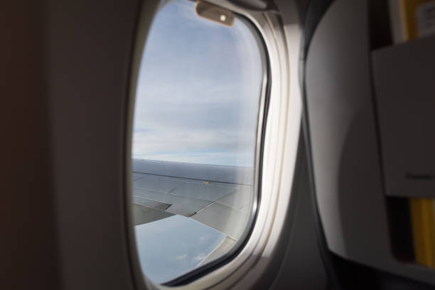 istock Clouds sky and aircraft wing as seen through window 1182778733