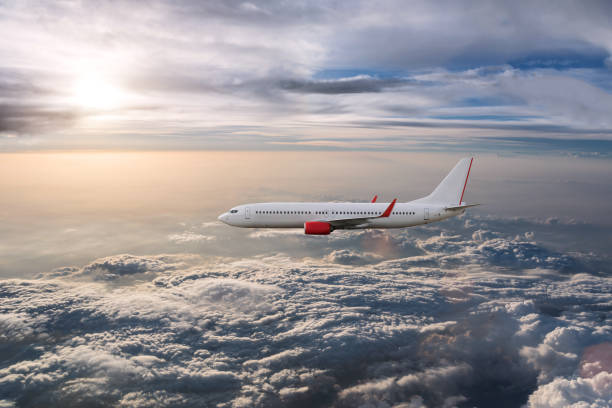 istock Airplane in the cloudy sky 1182779021