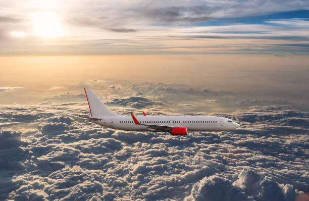 istock Airplane in the cloudy sky 1182779794