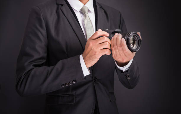 istock Young photographer man holding camera isolated 1182779981