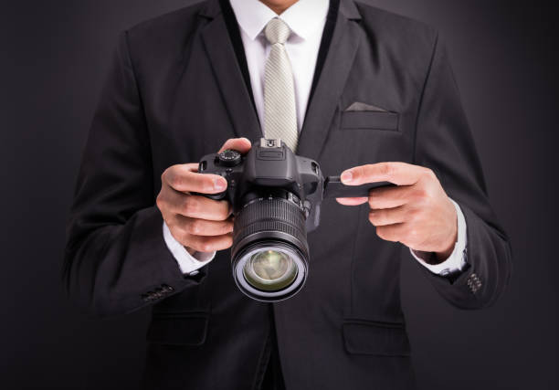 istock Young photographer man holding camera isolated 1182780142