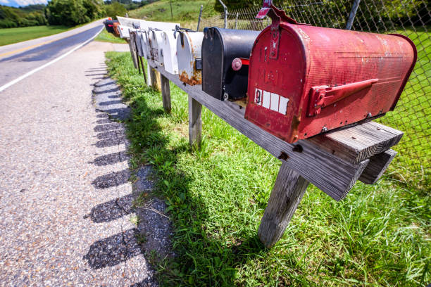 istock Row of vintage mailboxes next to a highway - U.S. mail 1182780279
