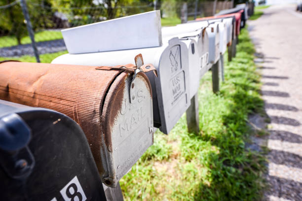 istock Row of vintage mailboxes next to a highway - U.S. mail 1182780282
