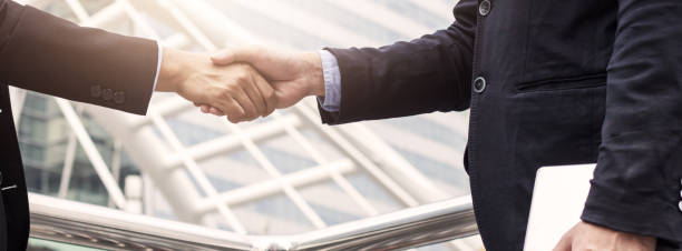 istock Success business, successful agreement negotiation and confident  partner cooperation concept, Businessman shake hands with customer in banner background 1182782839