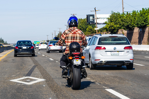 Oct 12, 2019 Redwood City / CA / USA - Motorcyclist riding on the freeway on the carpool lane