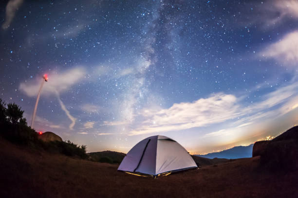 istock amping tent under the stars and distant city background 1182788731