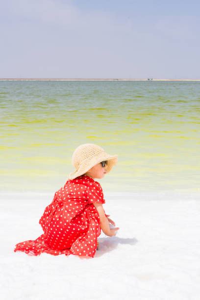 a young girl playing by the lake side