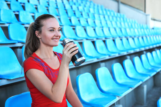 istock Beautiful sportswoman drinking water after work out. 1182790438