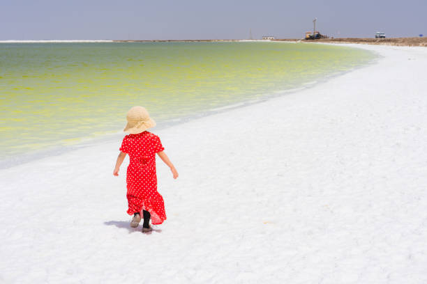 a young girl playing by the lake side