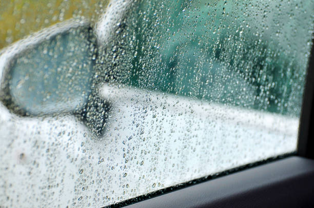 istock Water drops on car window glass during heavy rain 1182795494