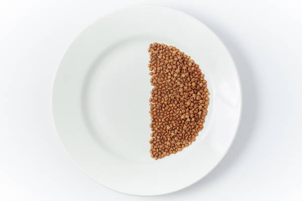 istock buckwheat in a white plate on a white background 1182798227