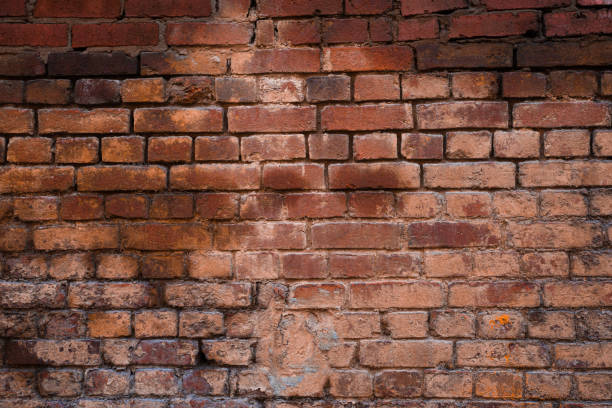 istock Texture of old brickwork with peeling color paint 1182798258