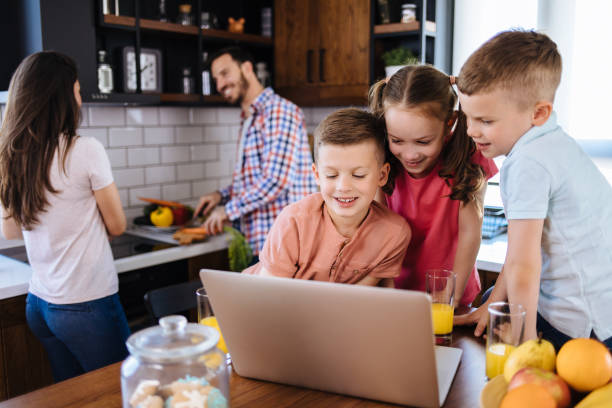 istock Children surfing the internet using laptop while having breakfast at home 1182803927