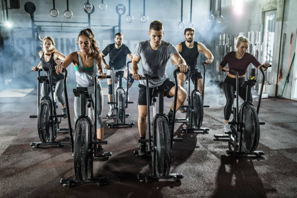 istock gym training on stationary bikes! 1182807378