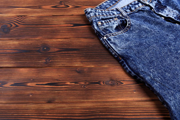 istock blue denim jeans  on wooden background - Image 1182810207