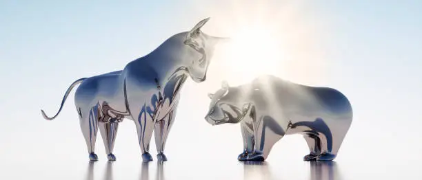 Silver Bull and Bear against a bright Sky with Sun