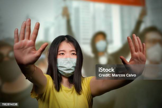 Young Beautiful Pacifist Asian Woman Angry And Outraged Protesting On Street Demonstration Against China Abuse Standing For Freedom And Human Rights Showing Clean Hands As Symbol Of Peace Stock Photo - Download Image Now