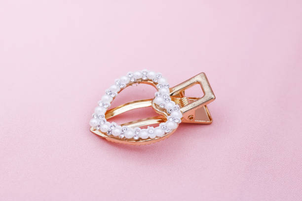 istock Luxury hair clip on pink fabric with copyspace. 1182815040