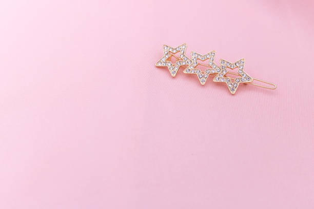 istock Luxury hair clip on pink fabric with copyspace. 1182815185