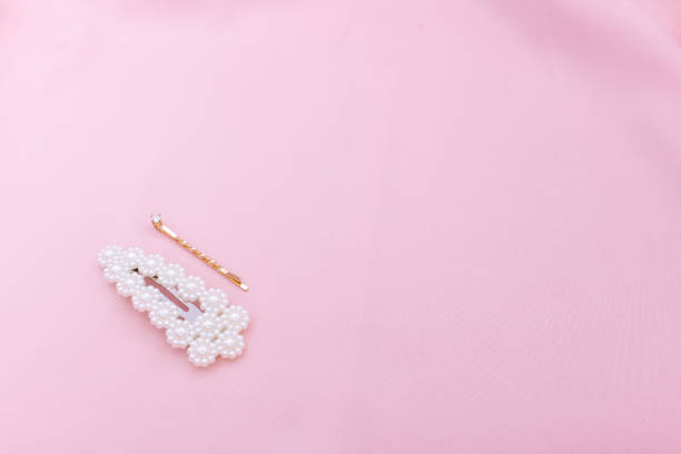 istock Luxury hair clips on pink fabric with copyspace. 1182815633