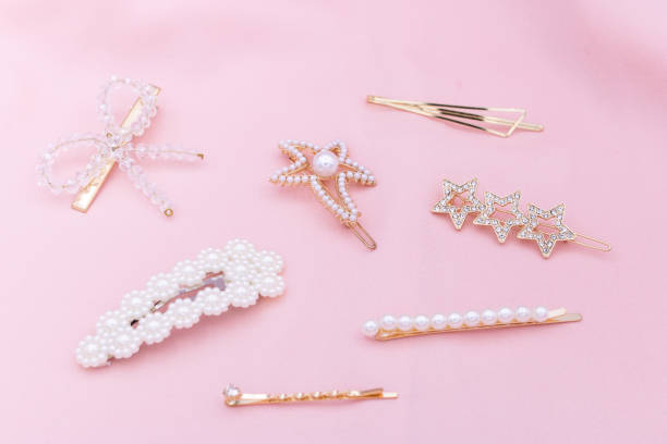 istock Luxury hair clips on pink fabric, beauty conecpt. 1182815662