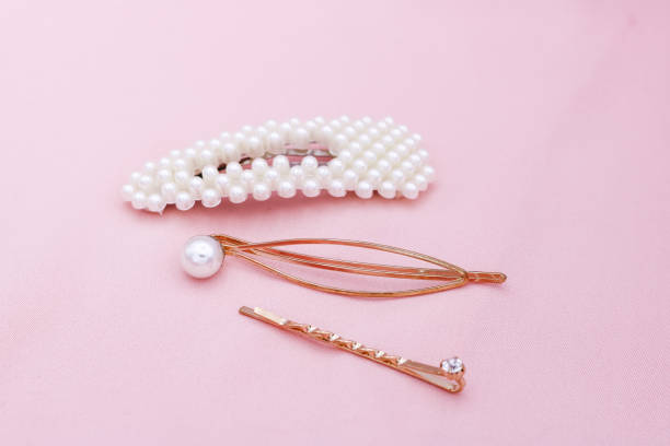 istock Luxury hair clips on pink fabric with copyspace. 1182815715