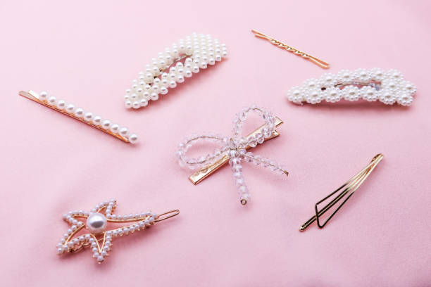 Luxury hair clips on pink fabric with copyspace.