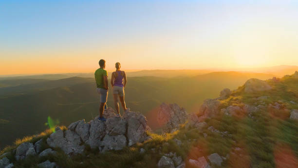 istock COPY SPACE: Young hiking couple observes the stunning landscape below them. 1182818301