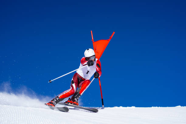 istock one professional skier touching poles at clear blue sky 1182818821