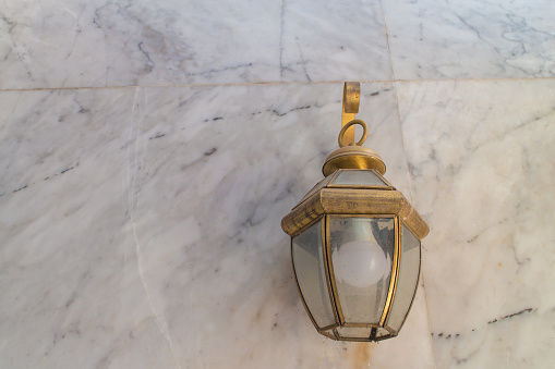 electrical lantern with marble wall background