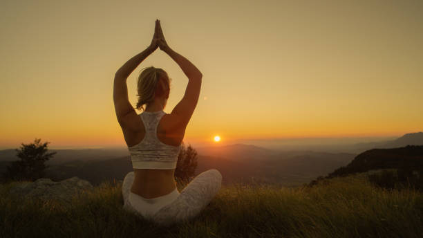istock CLOSE UP: Active woman doing yoga in the mountains on a sunny summer evening. 1182820344