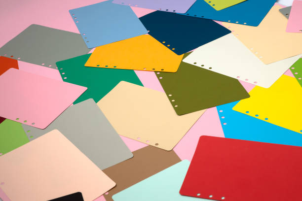 istock There are many different colored papers on the pink floor. 1182820703
