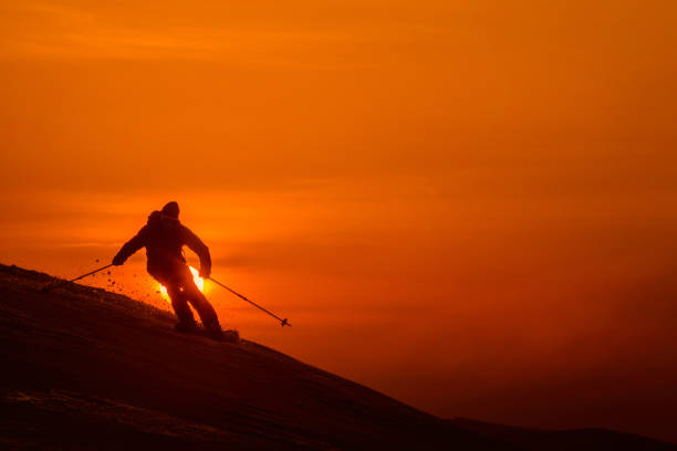 istock SILHOUETTE: Unrecognizable skier shredding the fresh untouched snow at sunset. 1182821525