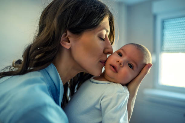 istock Holding tenderly her newborn baby boy 1182821751