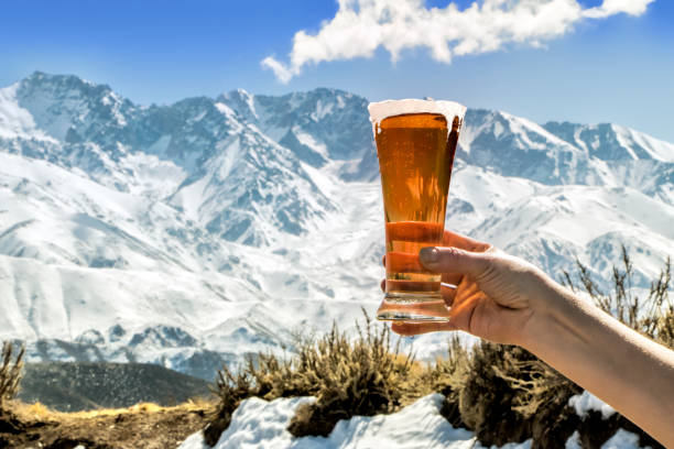 Photo of Tasty and fresh red beer at the foot of the snowy mountain.
