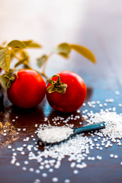 Face pack of hing or Asafoetida on wooden surface i.e. Hing powder well mixed with tomato pulp and sugar.For the treatment of skin whitening,.All the ingredients present on the surface.