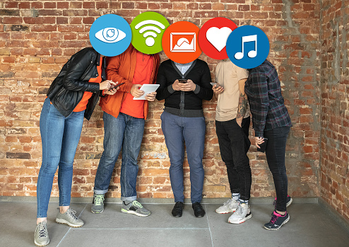Creative millenial people connecting and sharing social media. Modern UI icons as heads. Concept of contemporary technology, networking, gadgets in our common life. Yong happy men and women with smartphones and tablet.