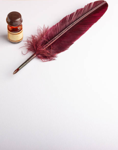 istock feather quill and inkwell on a white paper 1182825940