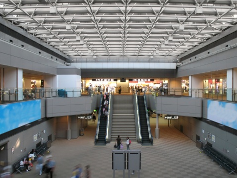 Navigational sign above the stairs at the airport. No people.