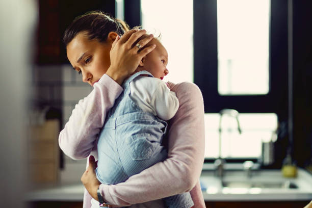 istock Affectionate mother consoling her baby at home. 1182829168
