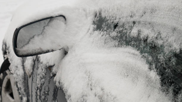 istock Left view mirror covered with snow. Snow Covered Rearview Mirror, car with frost. 1182829750